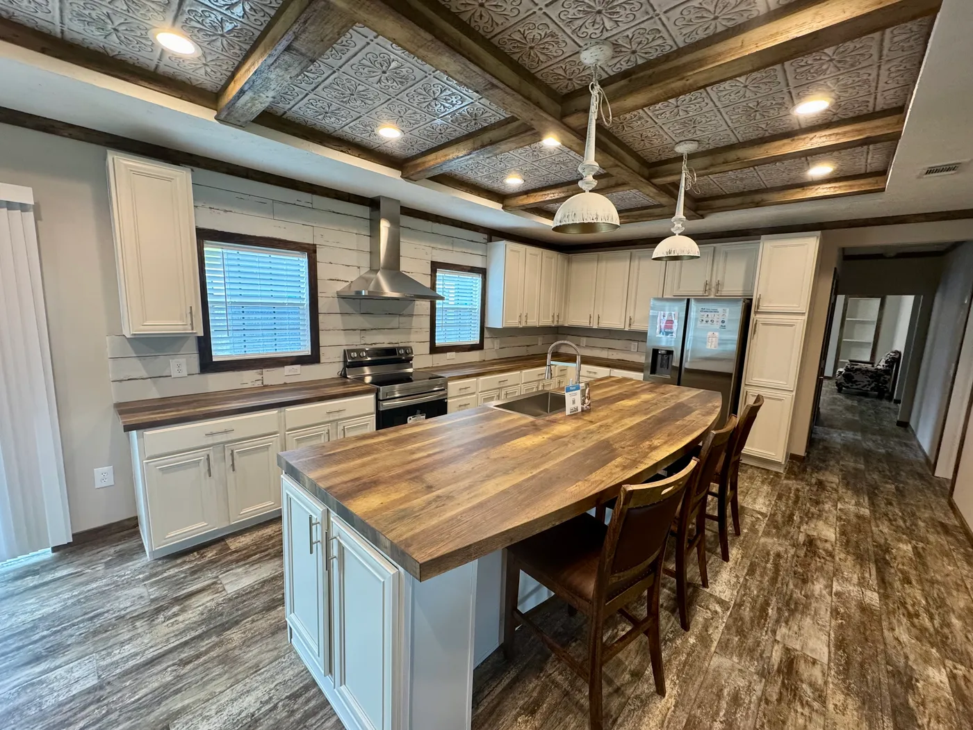 Check out the size of that bar! And those stainless steel appliances, gorgeous tile backsplash, and beautiful cabinets ??????