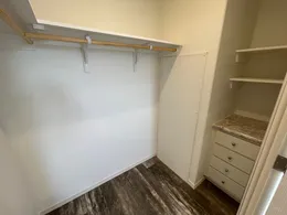 Huge primary closet with built in storage drawers and shelves.