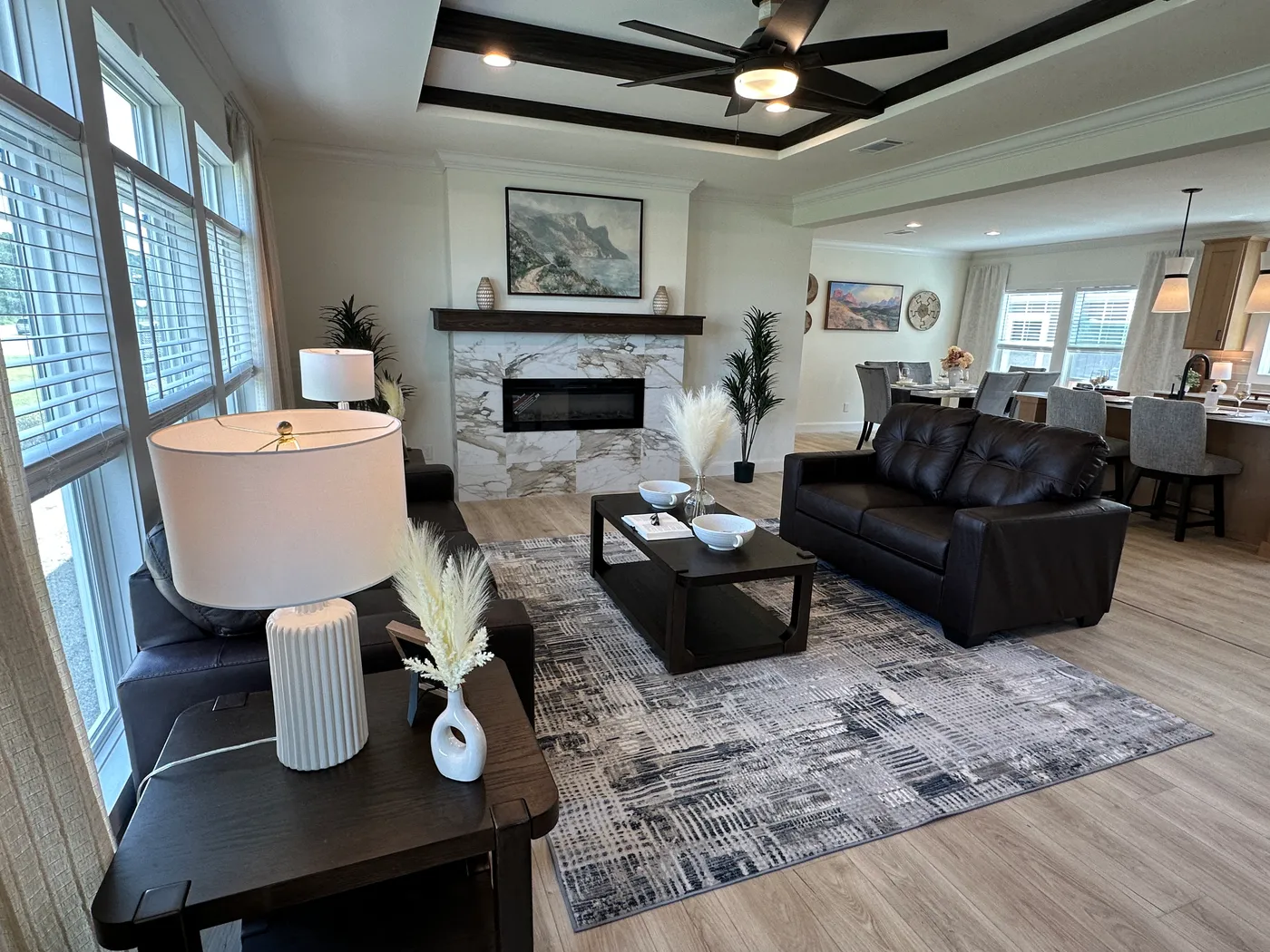 Discover The Cambridge, a stunning 3-bedroom, 2-bath luxury manufactured home at Clayton Homes of Alvin, Texas! This beautiful home features tape-and-textured walls, elegant crown molding, gorgeous quartz countertops, and a Samsung Smart Refrigerator. The gourmet kitchen includes a hidden walk-in Butler’s pantry with extra shelving and a second refrigerator for exceptional storage. The luxurious primary bedroom showcases a beautiful illuminated accent wall, while the spa-inspired primary bathroo