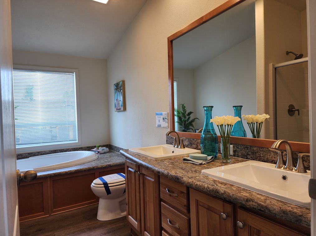 Glamour bathroom with large tub, dual sinks and walk-in shower.