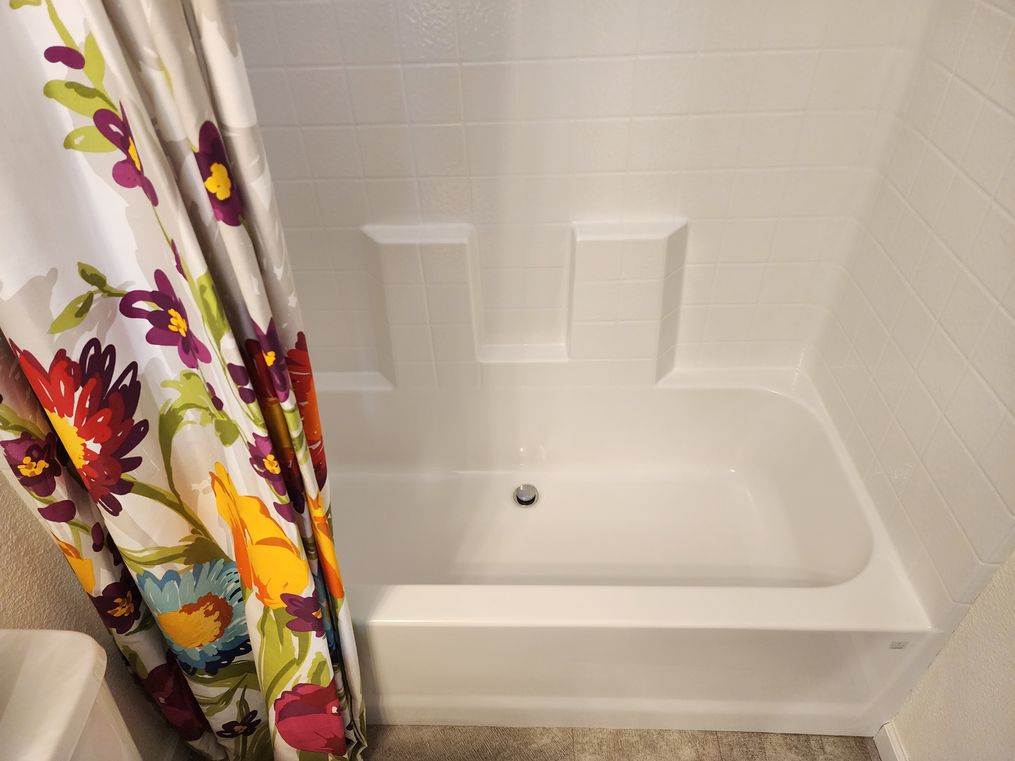 One-piece tub/shower combo.