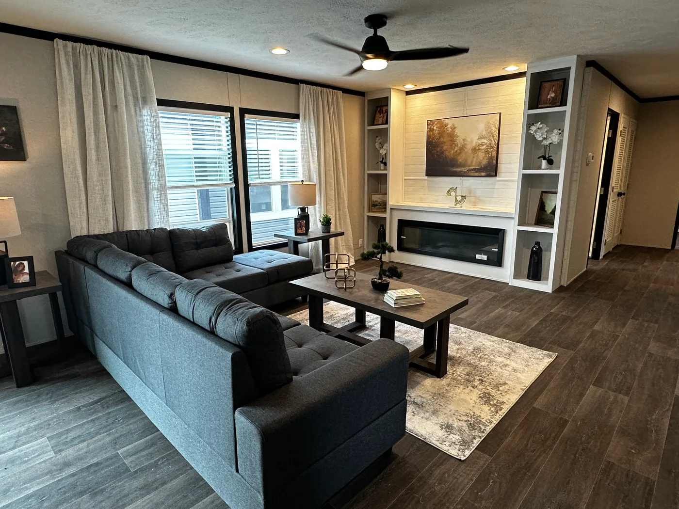 Spacious 4 bedroom 2 bath double wide manufactured home with massive square footage and modern design. Features an open floor plan with a large living room and separate den, perfect for entertaining or family living. The master suite offers a relaxing garden soaking tub, tiled-in walk-in shower, and plenty of space. Enjoy a cozy built-in fireplace, stylish finishes, and energy-efficient construction. This affordable mobile home is ideal for families seeking space, comfort, and value.