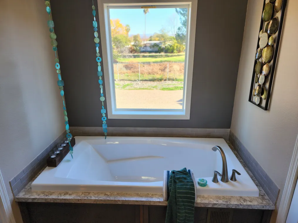 Large window over soaking tub... imagine your relaxing garden views