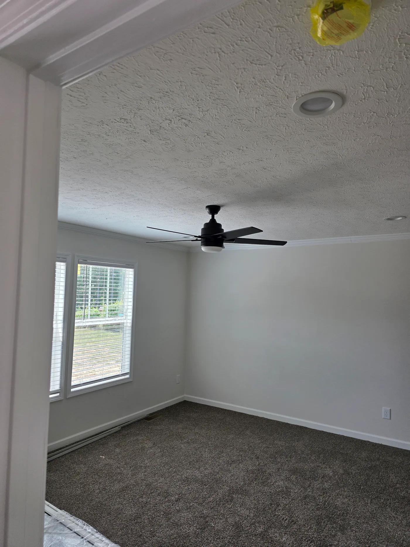 Primary bedroom with ceiling fan.  