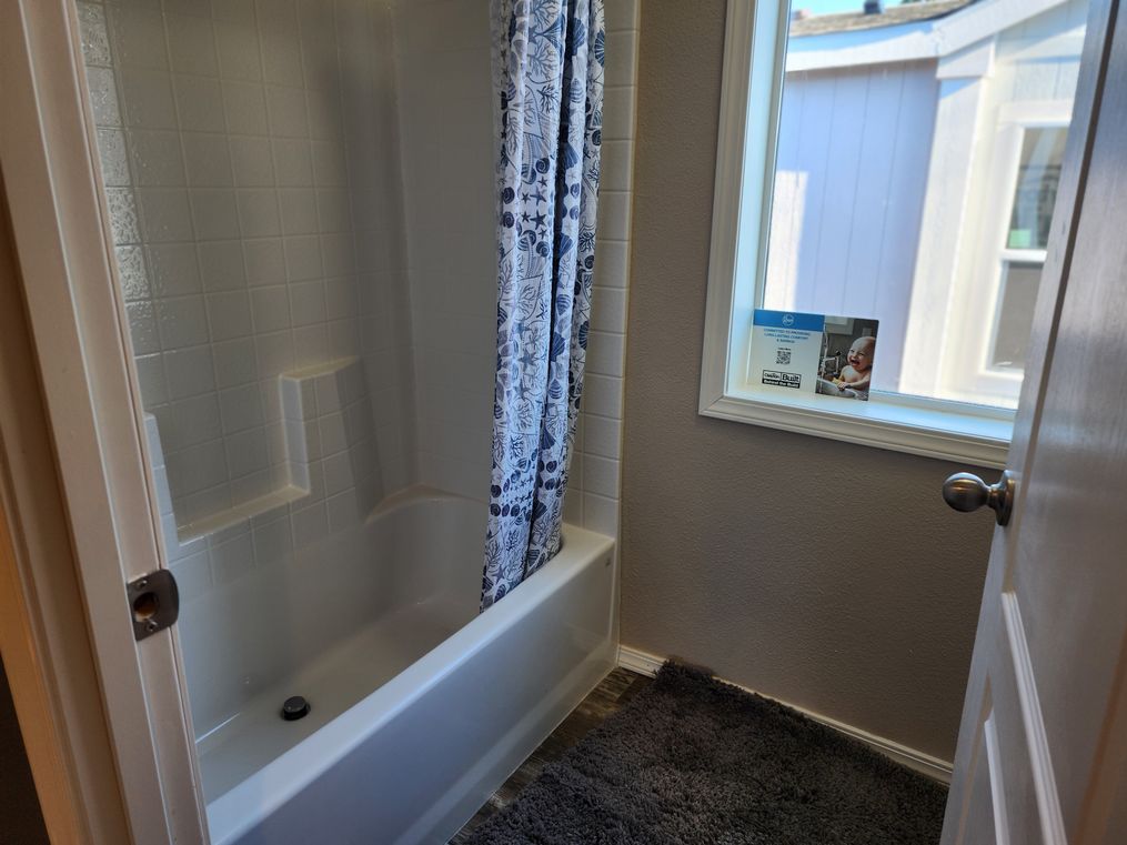Full length tub shower combo in guest bathroom