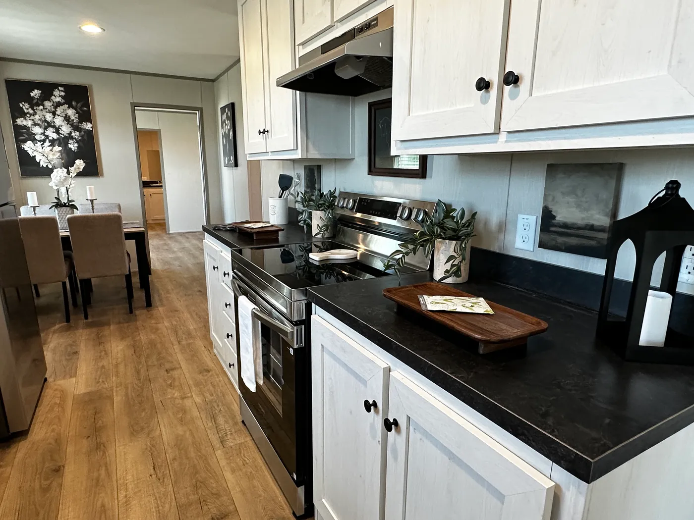 Affordable luxury meets modern comfort in this 3 bedroom, 2 bathroom manufactured home designed for spacious living and energy efficiency. The open-concept layout features a stylish kitchen with stainless steel appliances and a large walk-in pantry for extra storage. The private primary suite includes a generous walk-in closet and a relaxing retreat feel. Enjoy improved comfort with ceiling air vents for better airflow and temperature control throughout the home. This energy-efficient home offer