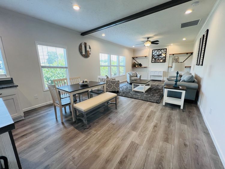 Open concept from the kitchen to dining room to living room. In new order homes, sliding glass or atrium door can be added to the dining room for more natural light. 