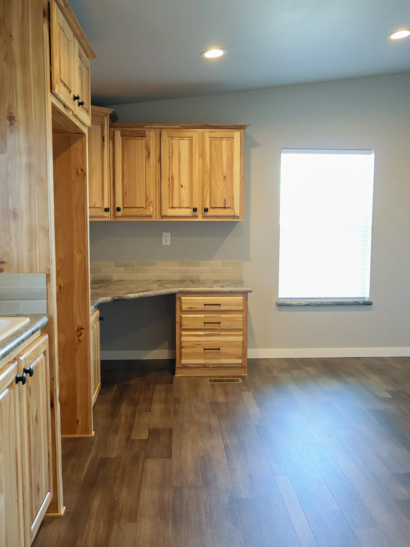 There is room for an office or hobby room in the utility room.