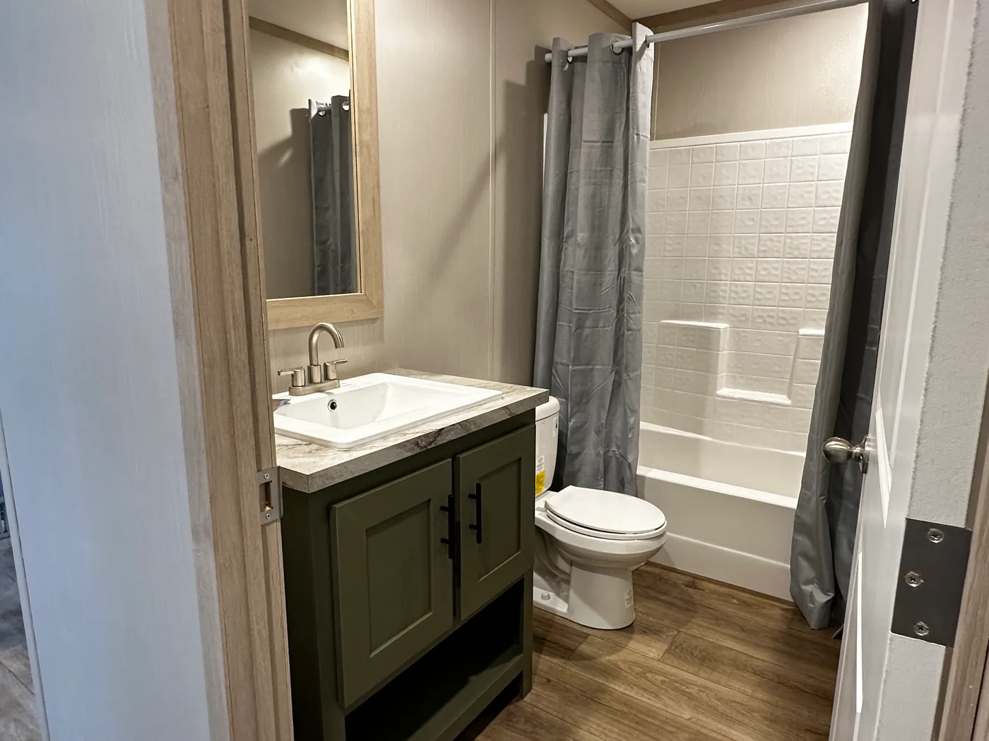 Spacious 3 bedroom, 2 bathroom double wide manufactured home built for comfort and family living. This open layout features both a living room and separate den, perfect for movie nights, entertaining, or creating private space for kids and adults. The modern kitchen includes stainless steel appliances and ample cabinet space. Enjoy year-round comfort with energy-efficient upflow ceiling vents for improved airflow. The private primary suite offers a relaxing retreat with a large soaking tub and s