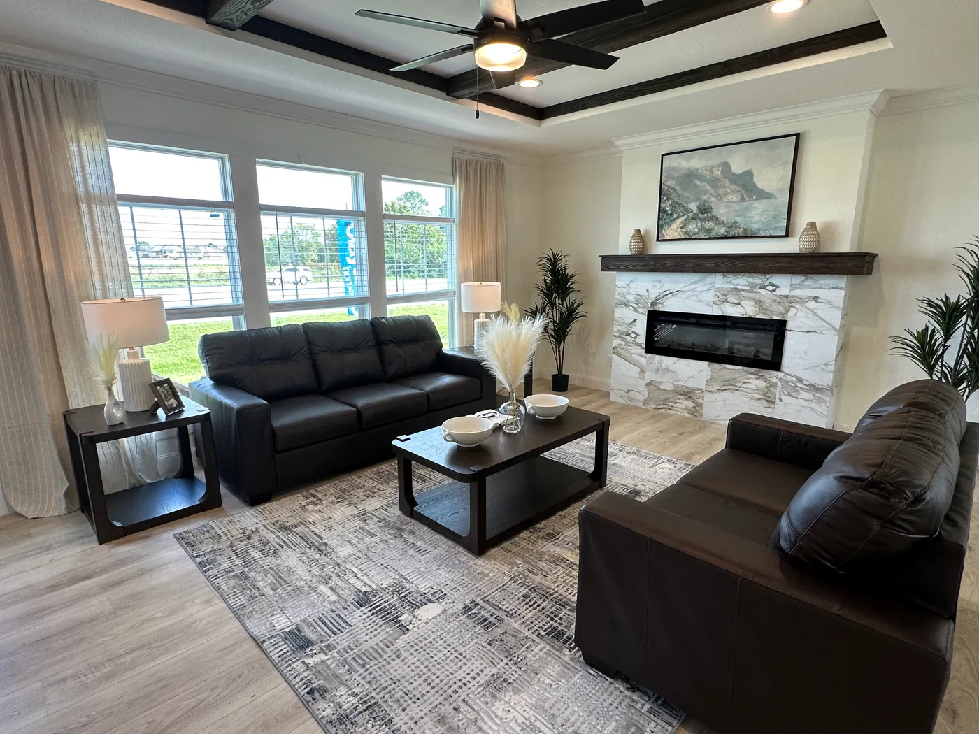 Discover The Cambridge, a stunning 3-bedroom, 2-bath luxury manufactured home at Clayton Homes of Alvin, Texas! This beautiful home features tape-and-textured walls, elegant crown molding, gorgeous quartz countertops, and a Samsung Smart Refrigerator. The gourmet kitchen includes a hidden walk-in Butler’s pantry with extra shelving and a second refrigerator for exceptional storage. The luxurious primary bedroom showcases a beautiful illuminated accent wall, while the spa-inspired primary bathroo