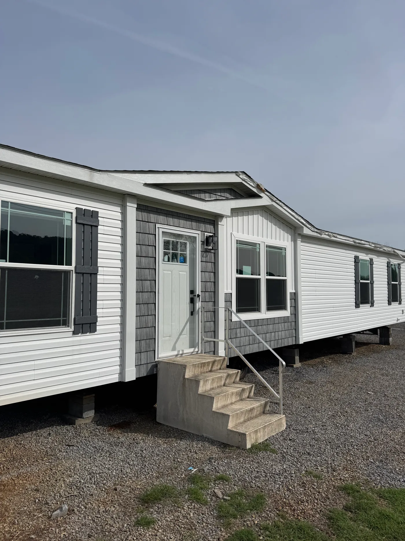 Eyebrow downer with accent shakes and vertical siding. 