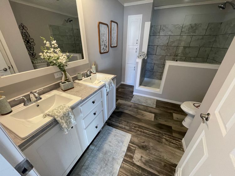 Ceramic Tile Walk In Shower with Dual Vanities in Primary Bathroom!