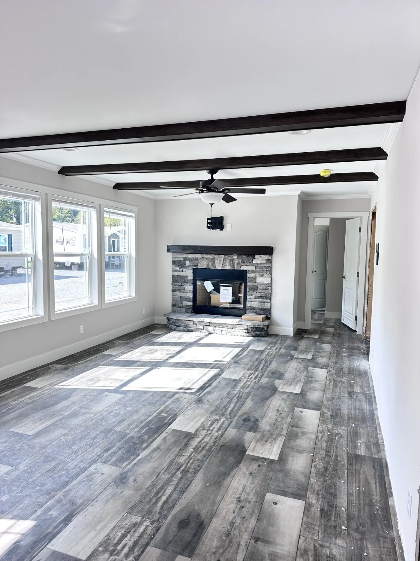 Family room with accent beams and wood burning fire place!