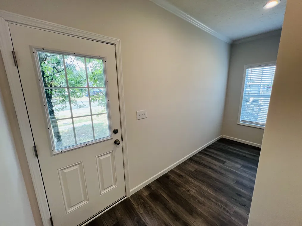 Utility room side door access to home. Perfect for a future addition of a garage. Excellent place to remove dirty clothing and shoes before coming into the remainder of the home. 