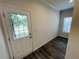 Utility room side door access to home. Perfect for a future addition of a garage. Excellent place to remove dirty clothing and shoes before coming into the remainder of the home. 