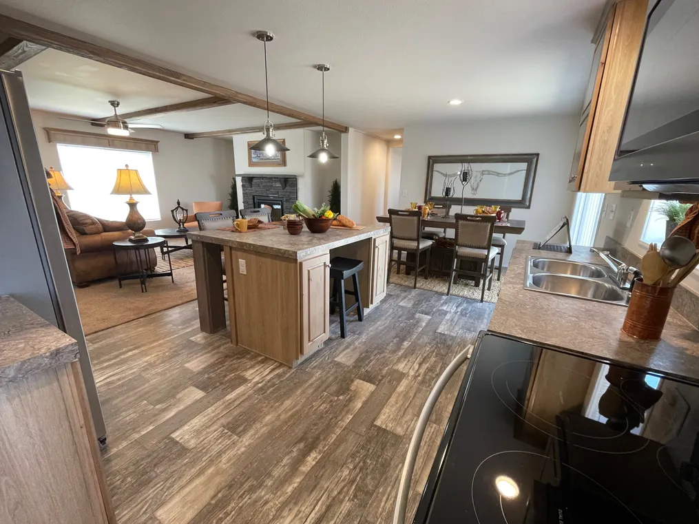 Huge kitchen island and stainless steel appliances.
