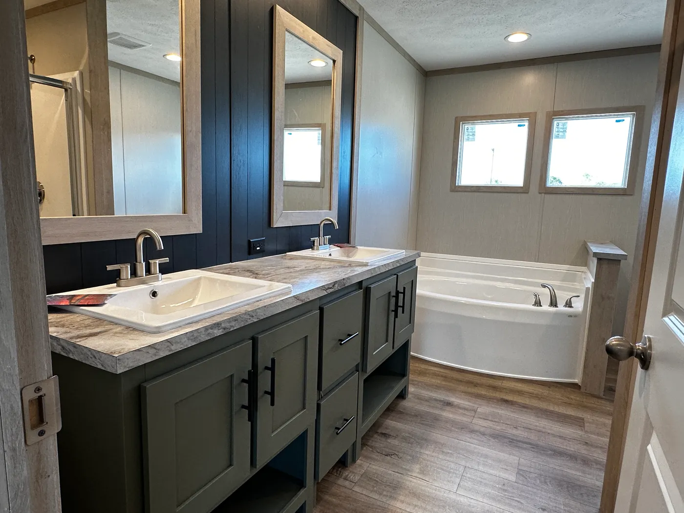 Spacious 3 bedroom, 2 bathroom double wide manufactured home built for comfort and family living. This open layout features both a living room and separate den, perfect for movie nights, entertaining, or creating private space for kids and adults. The modern kitchen includes stainless steel appliances and ample cabinet space. Enjoy year-round comfort with energy-efficient upflow ceiling vents for improved airflow. The private primary suite offers a relaxing retreat with a large soaking tub and s