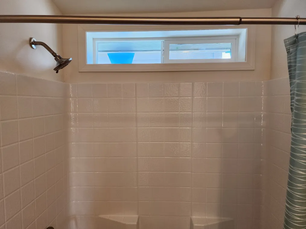 Window over shower for light and ventilation.