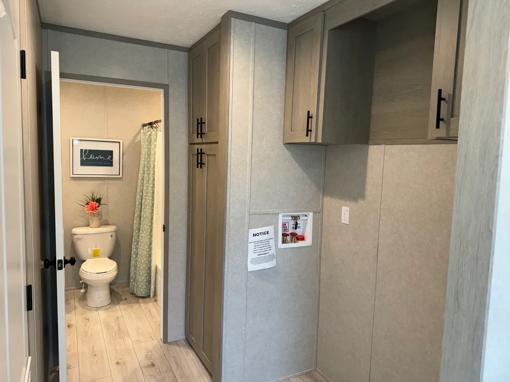 Utility storage and access to guest bath off of laundry area