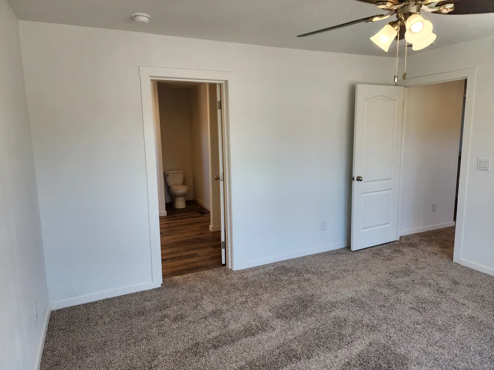 Door to primary bathroom on left and living room on right