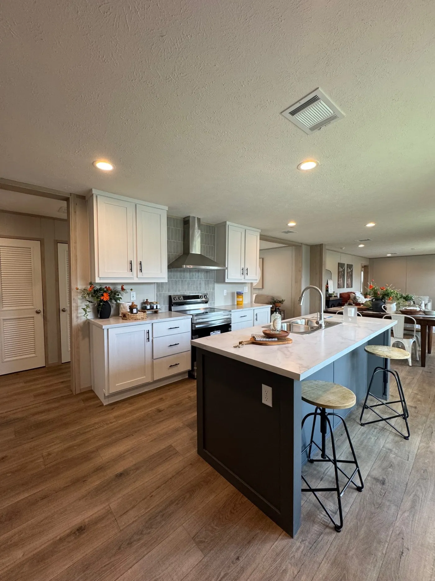 Kitchen w/ stainless steel Samsung appliances & island