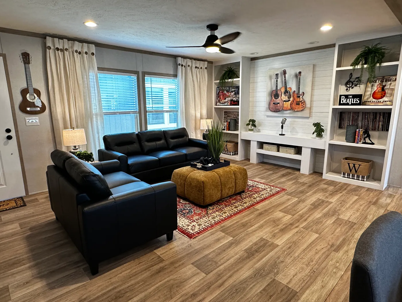 Modern luxury meets affordability in this 3 bedroom, 2 bathroom double wide manufactured home designed for comfort and style. The open-concept layout features a spacious living area with a gorgeous built-in entertainment center and plenty of natural light. The designer kitchen includes stainless steel appliances, a large kitchen island, and ample cabinet space, perfect for cooking and entertaining. Enjoy enhanced comfort with energy-efficient upflow ceiling vents for improved airflow throughout 