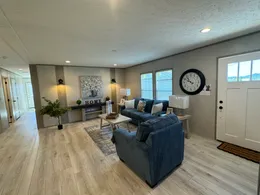 Open concept living room with craftsman front door