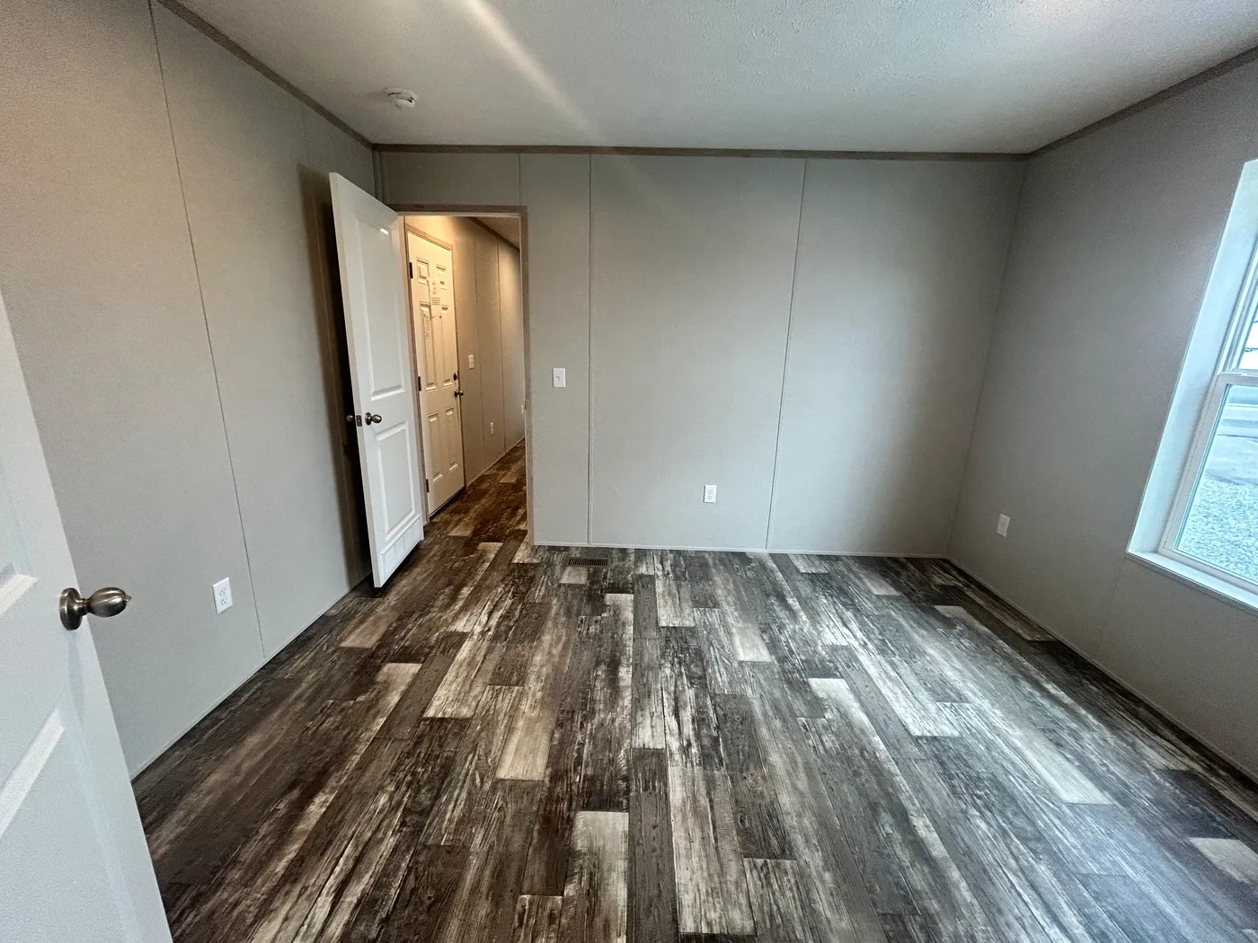 A view of the main bedroom from inside the main bathroom. 