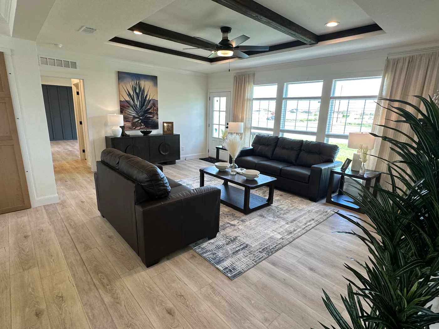 Discover The Cambridge, a stunning 3-bedroom, 2-bath luxury manufactured home at Clayton Homes of Alvin, Texas! This beautiful home features tape-and-textured walls, elegant crown molding, gorgeous quartz countertops, and a Samsung Smart Refrigerator. The gourmet kitchen includes a hidden walk-in Butler’s pantry with extra shelving and a second refrigerator for exceptional storage. The luxurious primary bedroom showcases a beautiful illuminated accent wall, while the spa-inspired primary bathroo