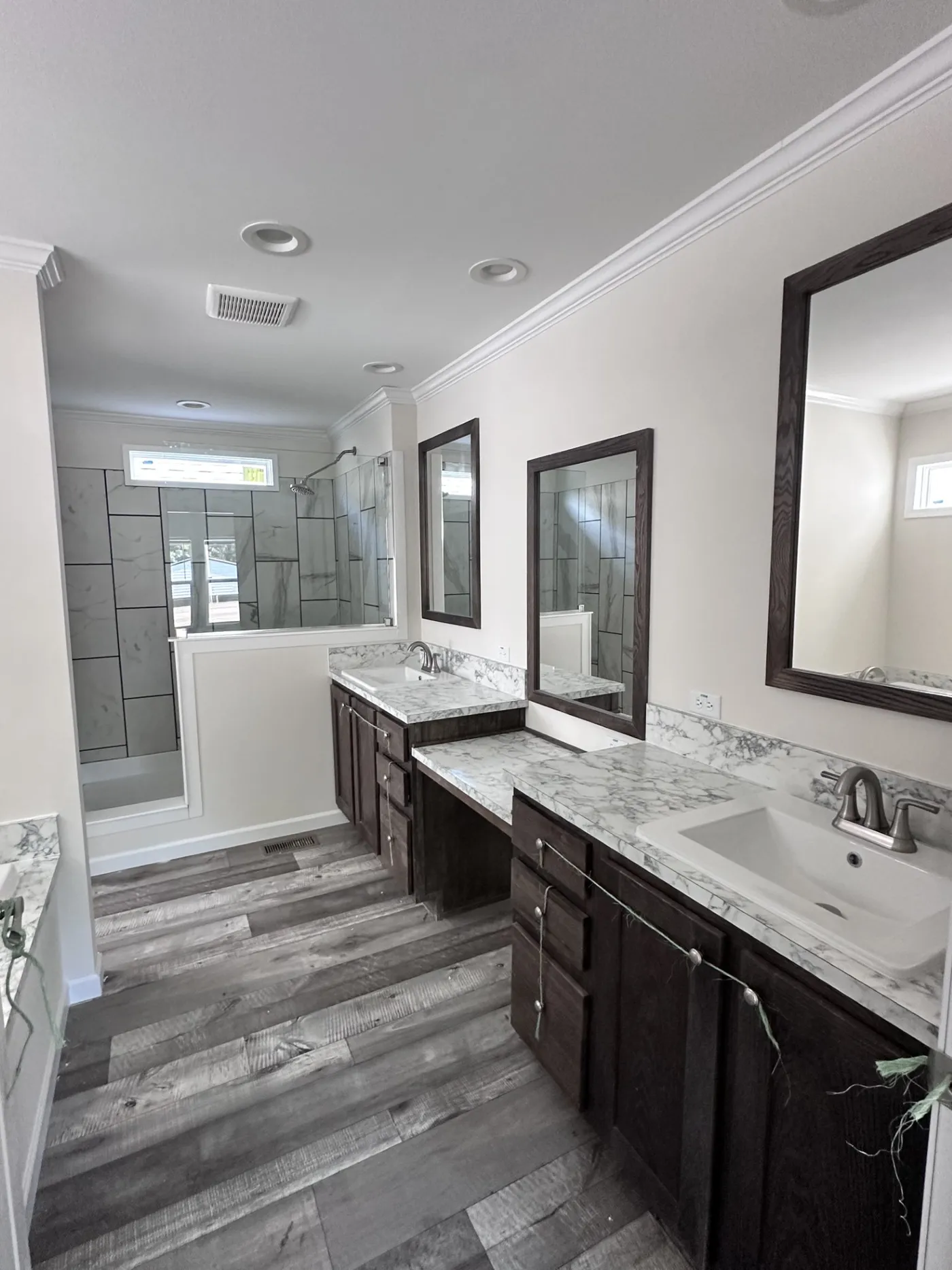 Double Vanity, soaking tub, & Tile Shower adorn this Primary Bathroom
