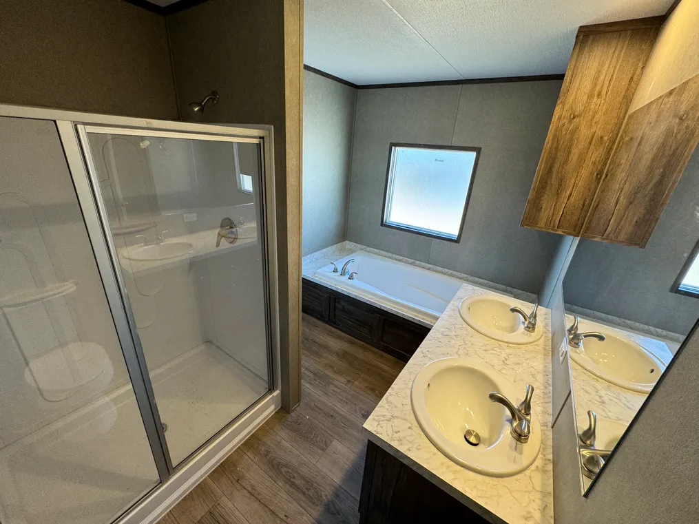 Walk-in shower in addition to the 72" oversized soaking tub along with dual porcelain sink vanity.