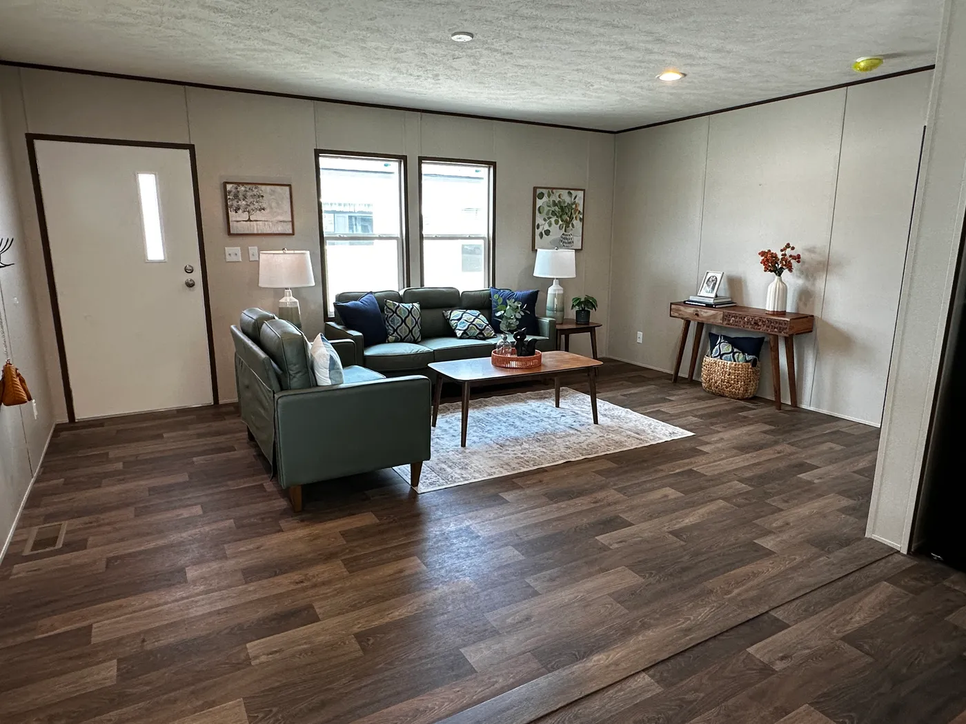 Discover the most affordable and spacious 4 bedroom, 2 bath doublewide manufactured home on the market! This budget-friendly mobile home features elevated ceilings, an open-concept layout, and plenty of room to grow with both a living room and separate den—perfect for entertaining, relaxing, or family space. The modern kitchen includes a large center island with ample storage and workspace. The private primary suite offers a walk-in closet, plus a luxury separate soaking tub and walk-in shower f