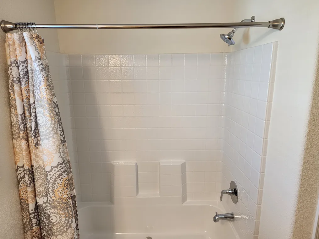 One-piece tub/shower combo in primary bathroom