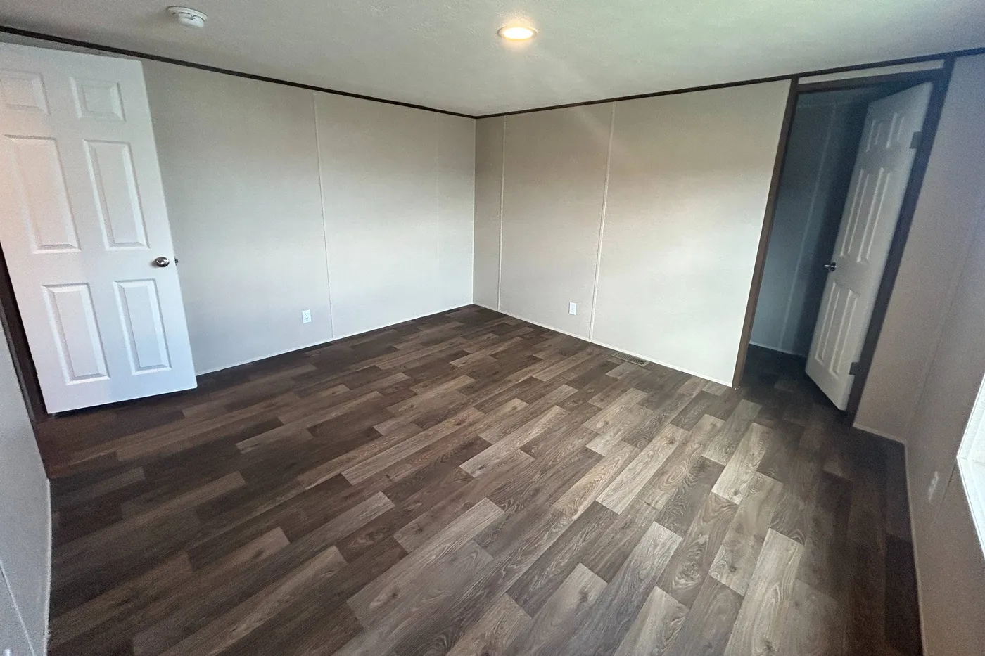 A view from inside one of the guest bedrooms with the closet entry shown. 