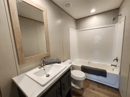 Guest bathroom with tub/shower combo, and a porcelain sink