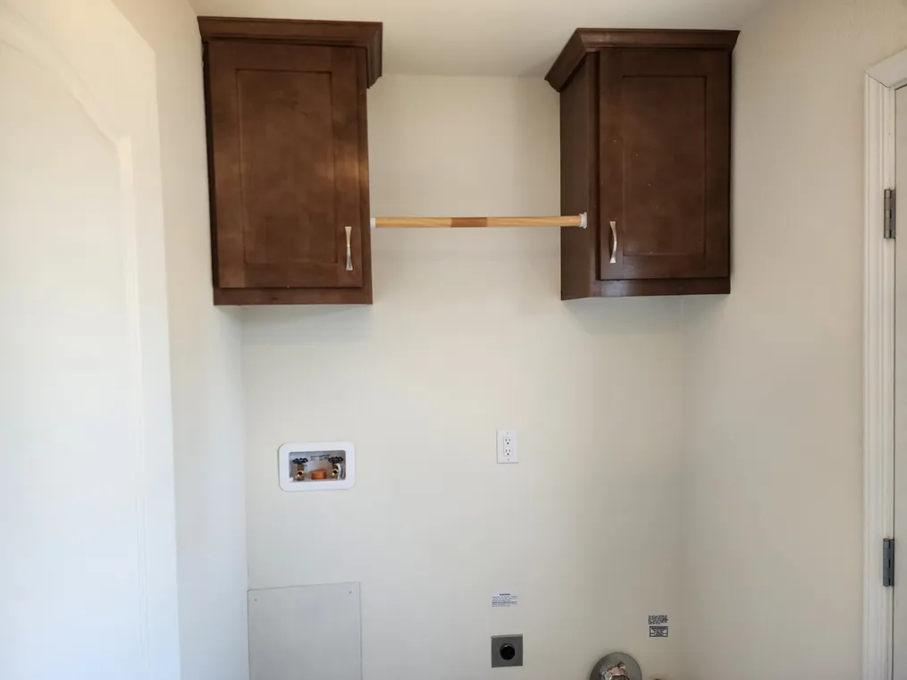 Cabinets & pole above laundry area.