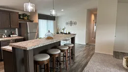Oversized island with dining area and butlers pantry.